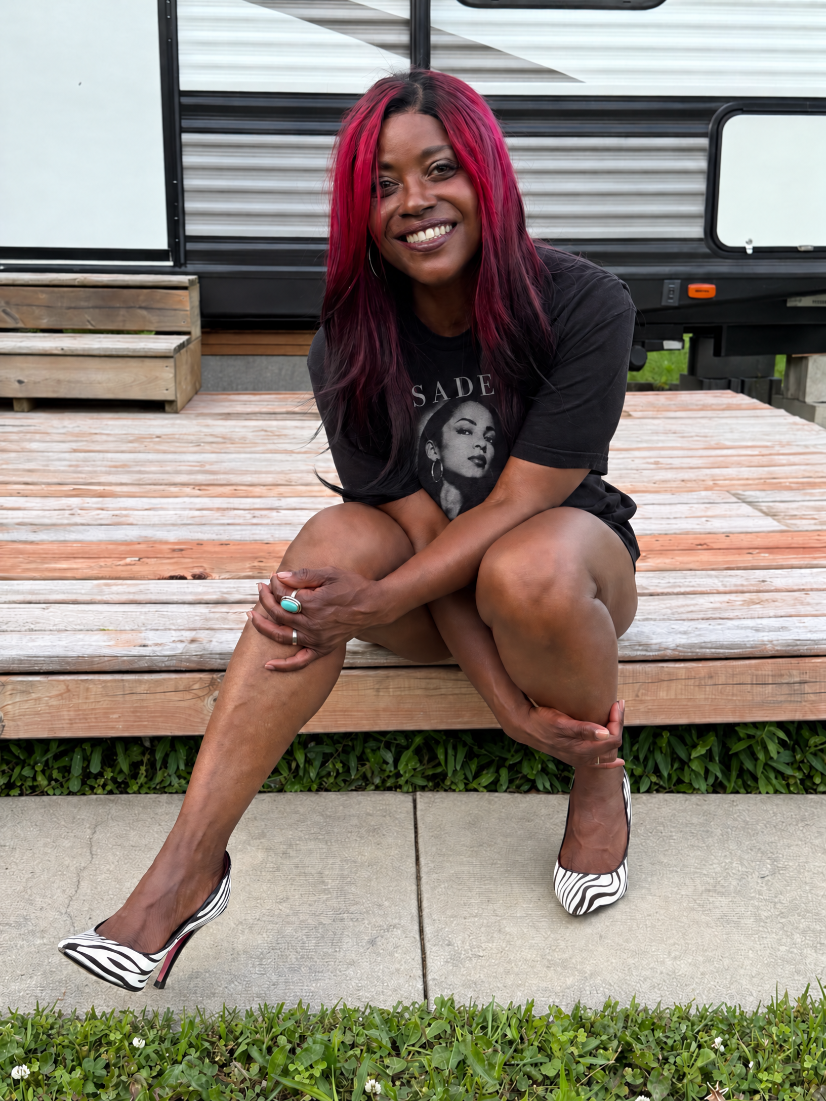 Shelley Hamilton seated outdoors in a black Sade shirt